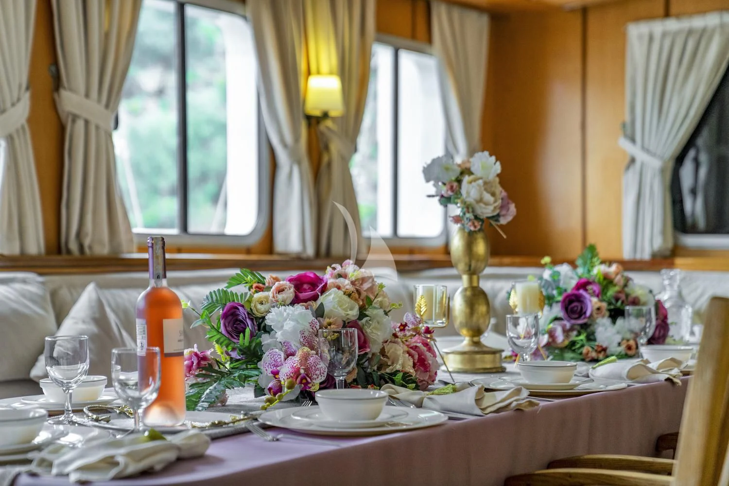 a table with flowers and candles aboard TERSANE 8 Yacht for Sale