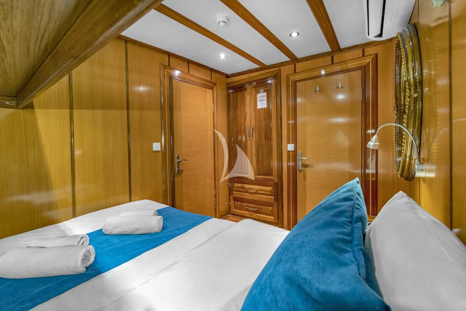 a bed with blue sheets aboard TERSANE 8 Yacht for Sale