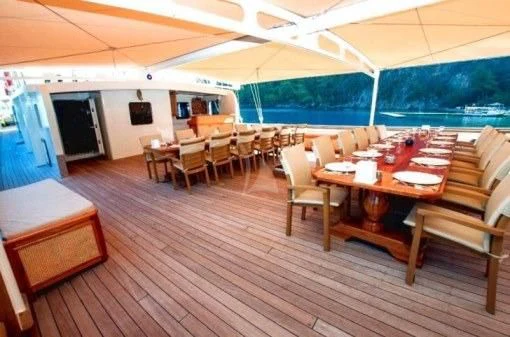 a room with tables and chairs aboard TERSANE 8 Yacht for Sale