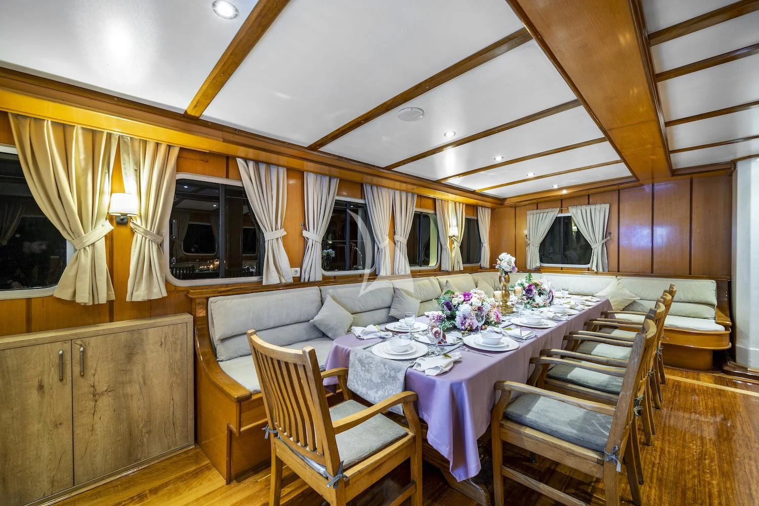 a dining table and chairs in a room with a bed and a couch aboard TERSANE 8 Yacht for Sale