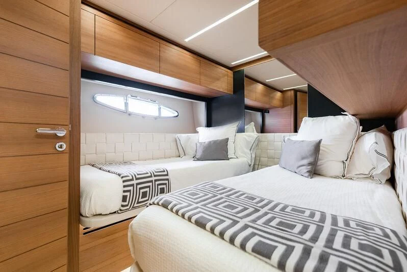 a room with a couple of beds aboard TINE V Yacht for Sale
