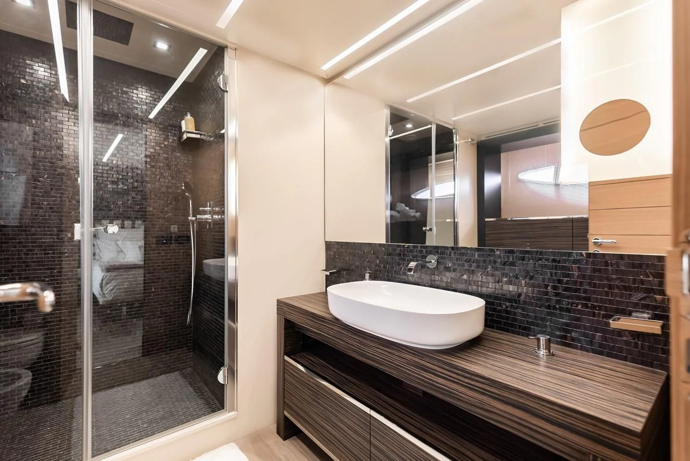 a bathroom with a large mirror aboard TINE V Yacht for Sale