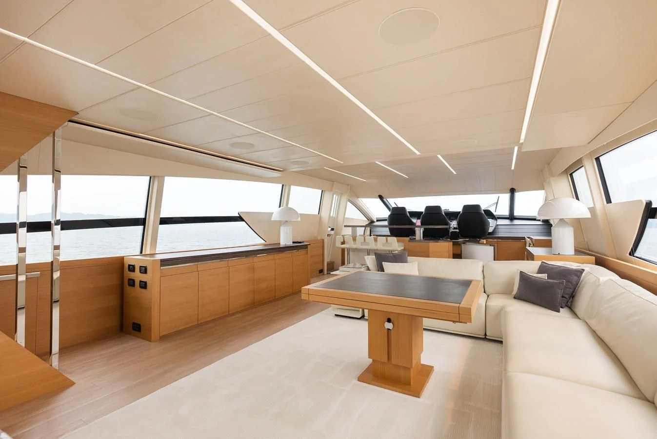a room with a table and couch aboard TINE V Yacht for Sale