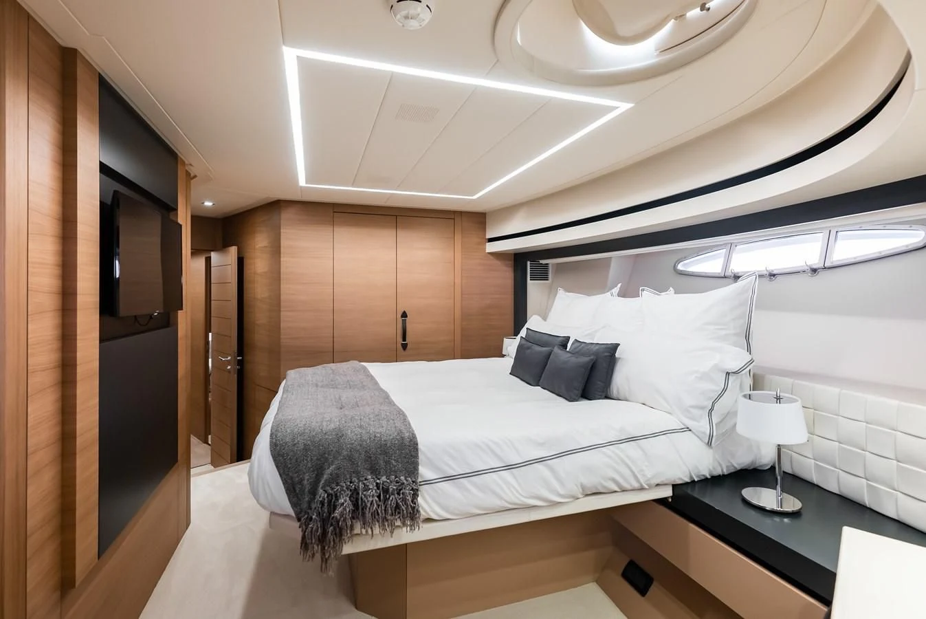 a bedroom with a bed and a wood wall aboard TINE V Yacht for Sale