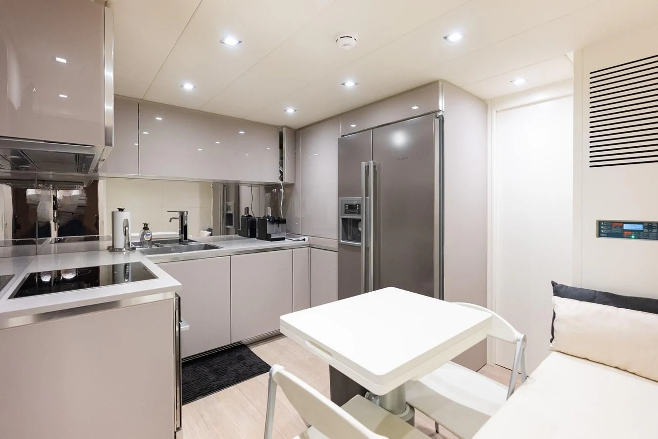 a kitchen with a fridge and a table aboard TINE V Yacht for Sale