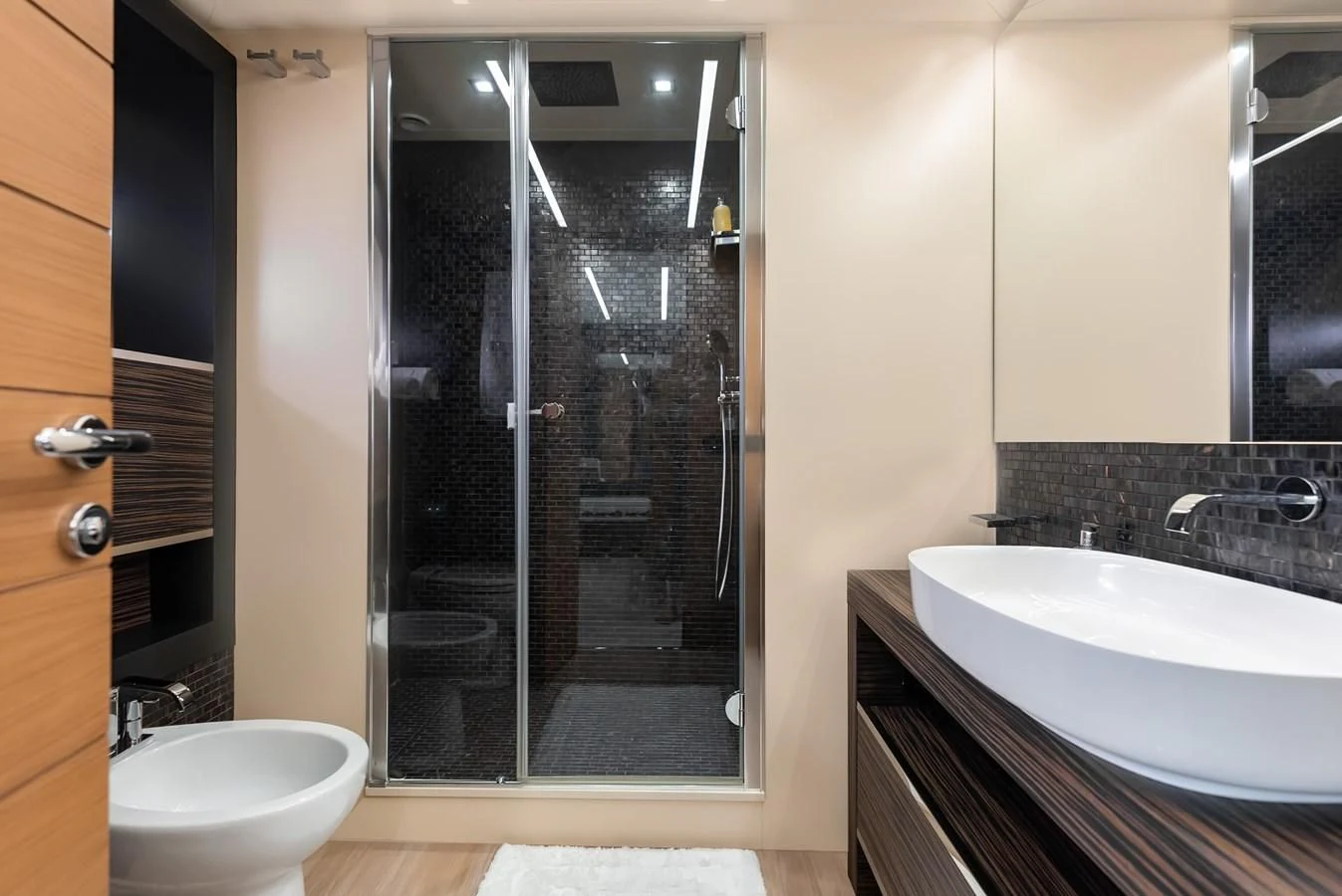 a bathroom with a glass shower aboard TINE V Yacht for Sale