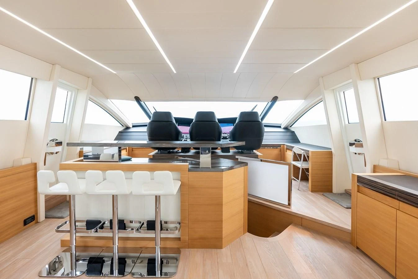 a room with desks and chairs aboard TINE V Yacht for Sale