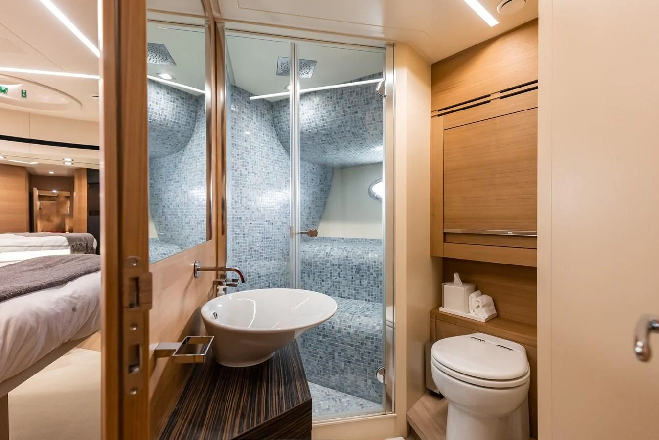 a bathroom with a glass shower aboard TINE V Yacht for Sale