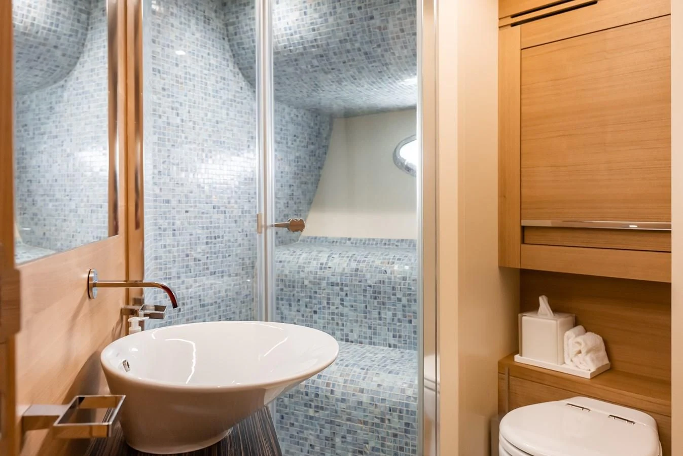 a bathroom with a sink and a mirror aboard TINE V Yacht for Sale