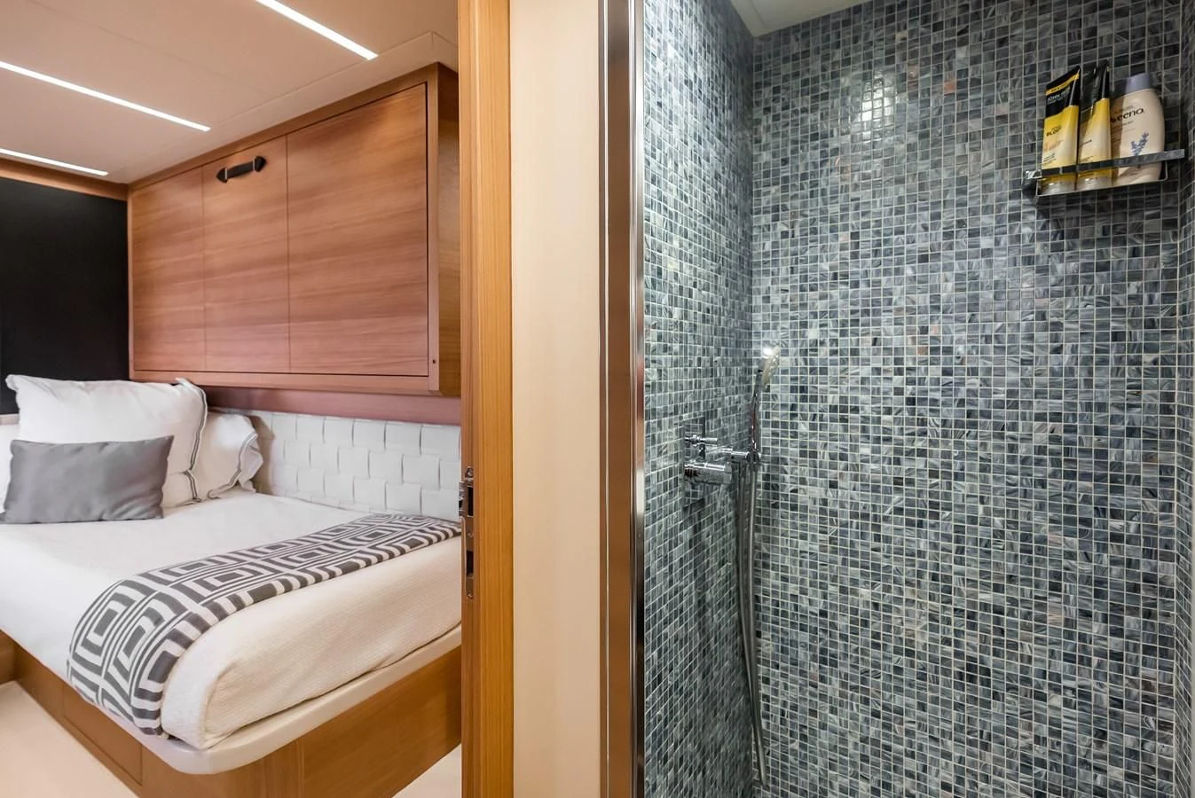 a room with a bed and a shower aboard TINE V Yacht for Sale