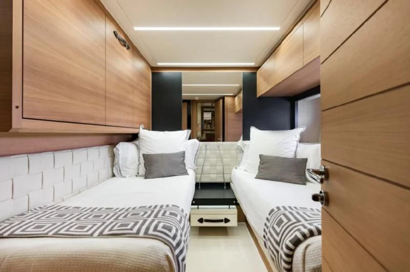 a room with a couple of beds aboard TINE V Yacht for Sale