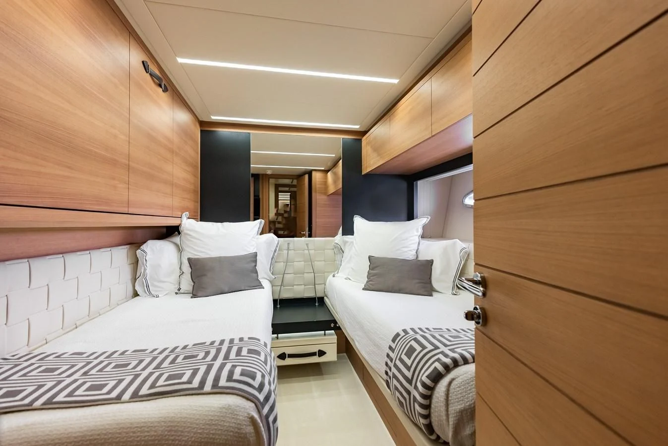 a room with a couple of beds aboard TINE V Yacht for Sale
