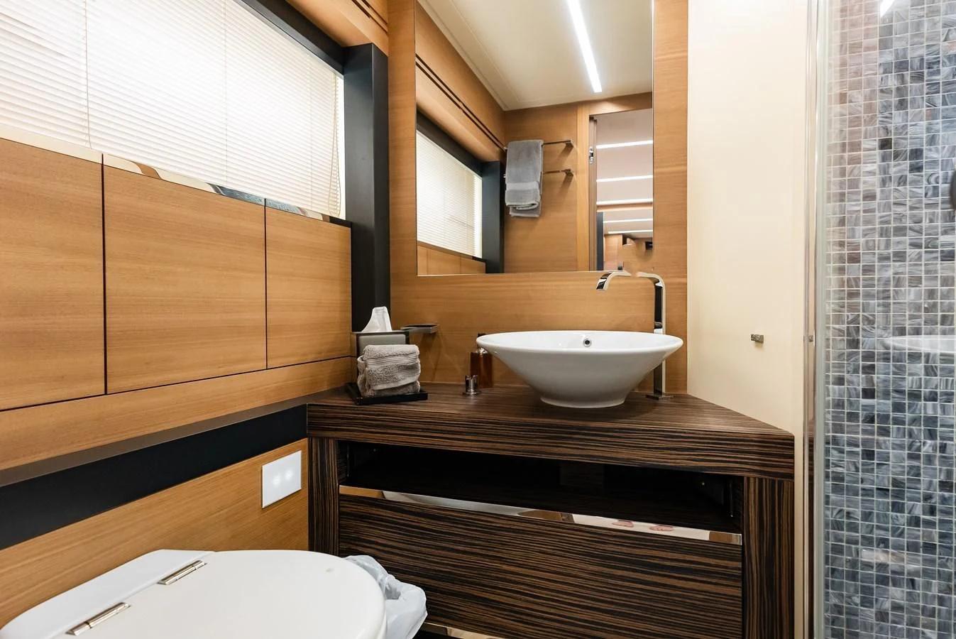 a bathroom with a sink and a mirror aboard TINE V Yacht for Sale
