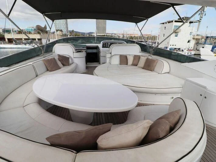 a large white lounge chair on a boat with a large white round table and chairs and a large aboard MAX & ALE Yacht for Sale