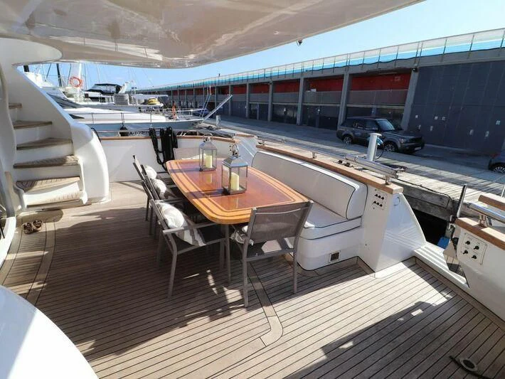 a table on a deck aboard MAX & ALE Yacht for Sale