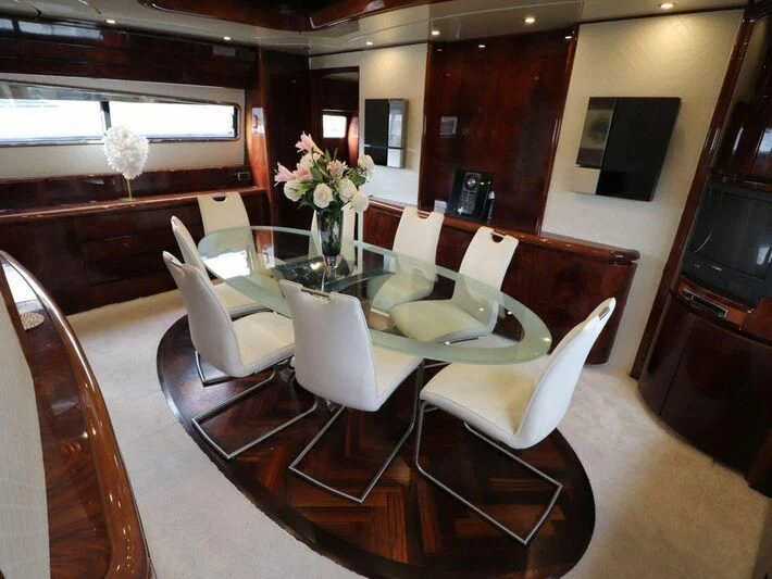 a dining room with white chairs aboard MAX & ALE Yacht for Sale