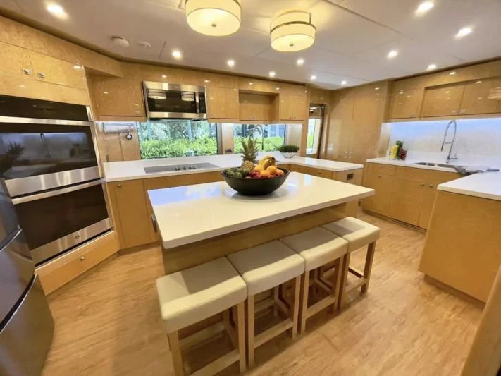 a kitchen with a large island aboard OBSESSION Yacht for Sale