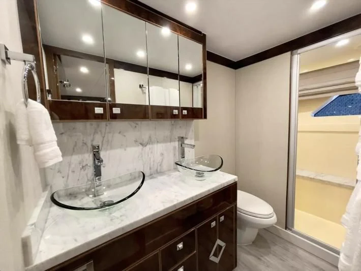 a bathroom with a sink and a mirror aboard OBSESSION Yacht for Sale