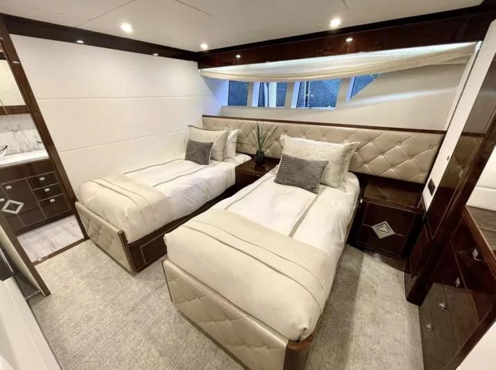 a room with a bed and a large mirror aboard OBSESSION Yacht for Sale