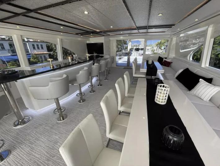 a room with a table chairs and a large window aboard OBSESSION Yacht for Sale