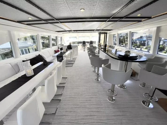 a room with a table and chairs aboard OBSESSION Yacht for Sale