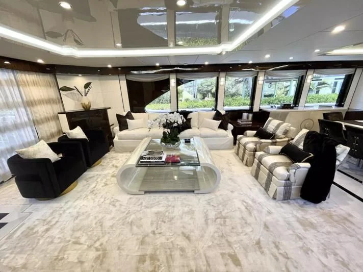 a large room with a couch and a coffee table aboard OBSESSION Yacht for Sale