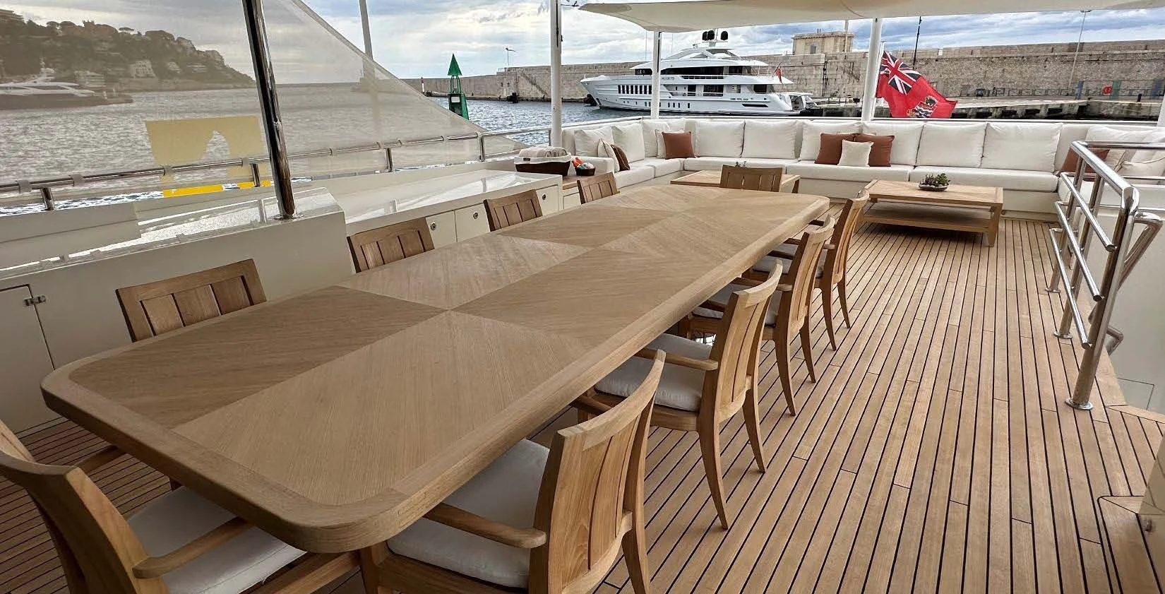 a wooden table on a deck aboard BELONGERS Yacht for Sale