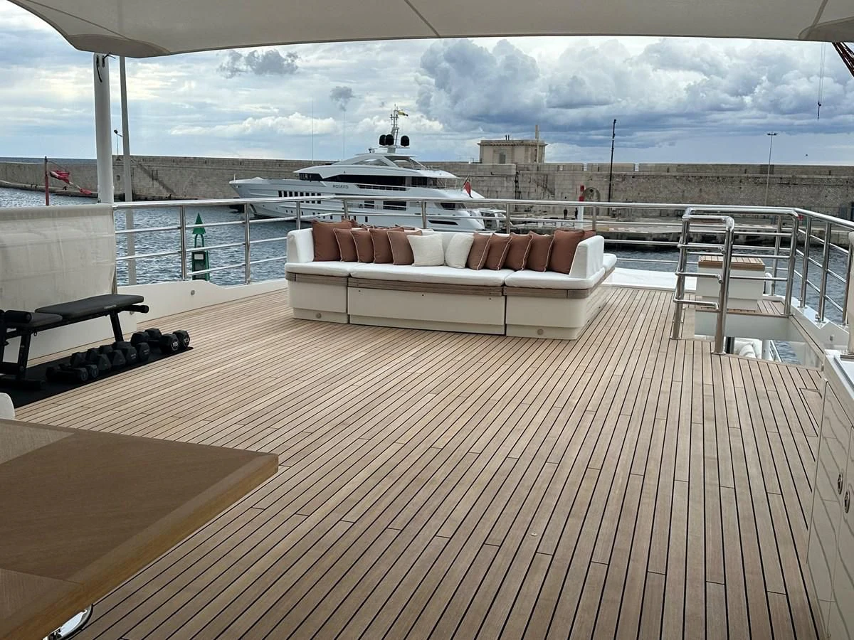 a large room with a couch and a large body of water aboard BELONGERS Yacht for Sale