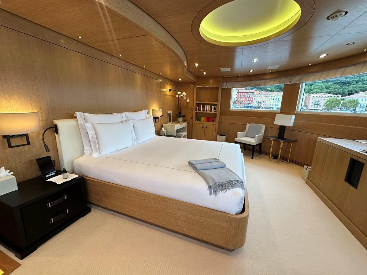 a hotel room with a bed and desk aboard BELONGERS Yacht for Sale