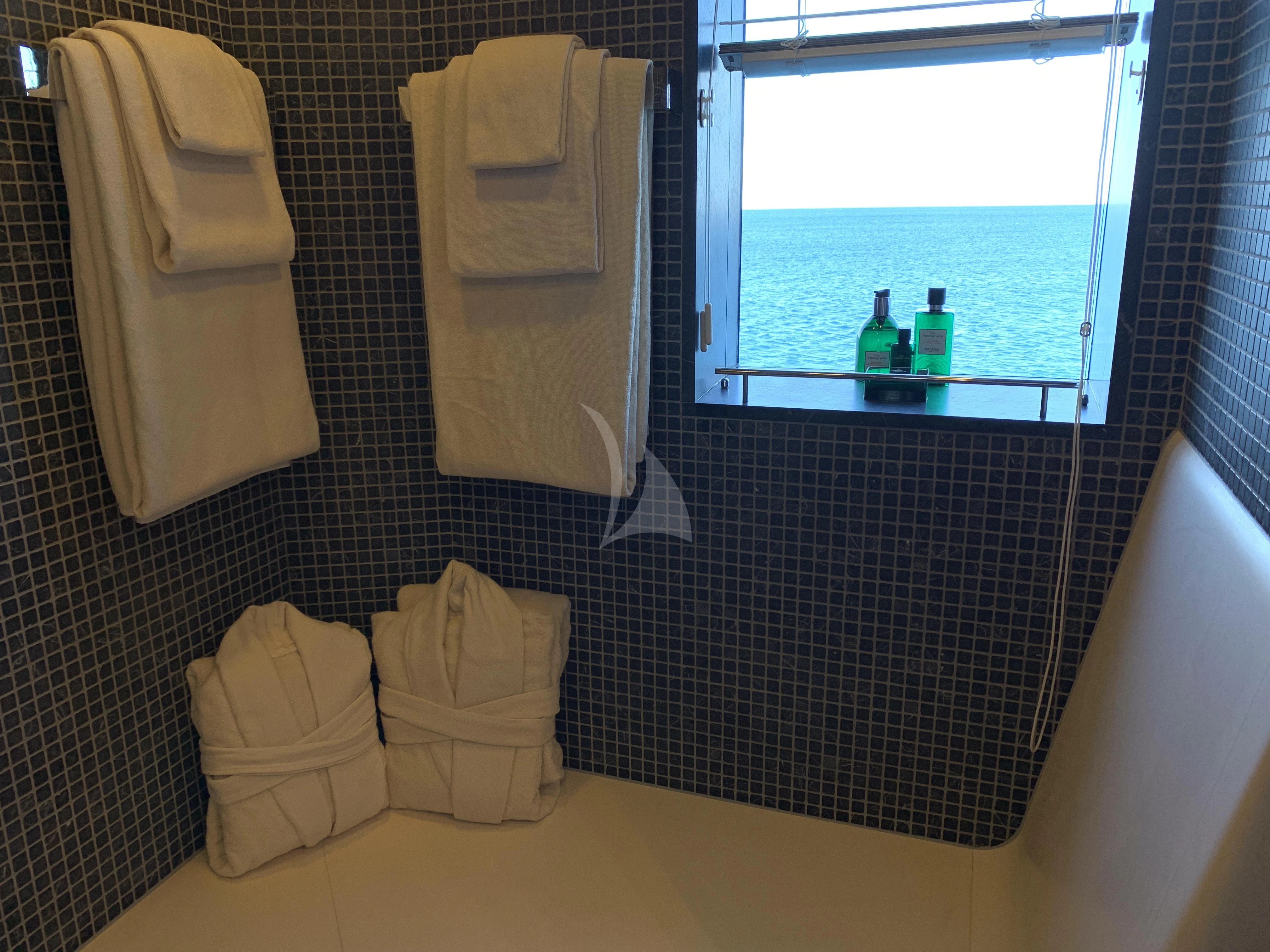 a bathroom with a window and a bathtub aboard BELONGERS Yacht for Sale