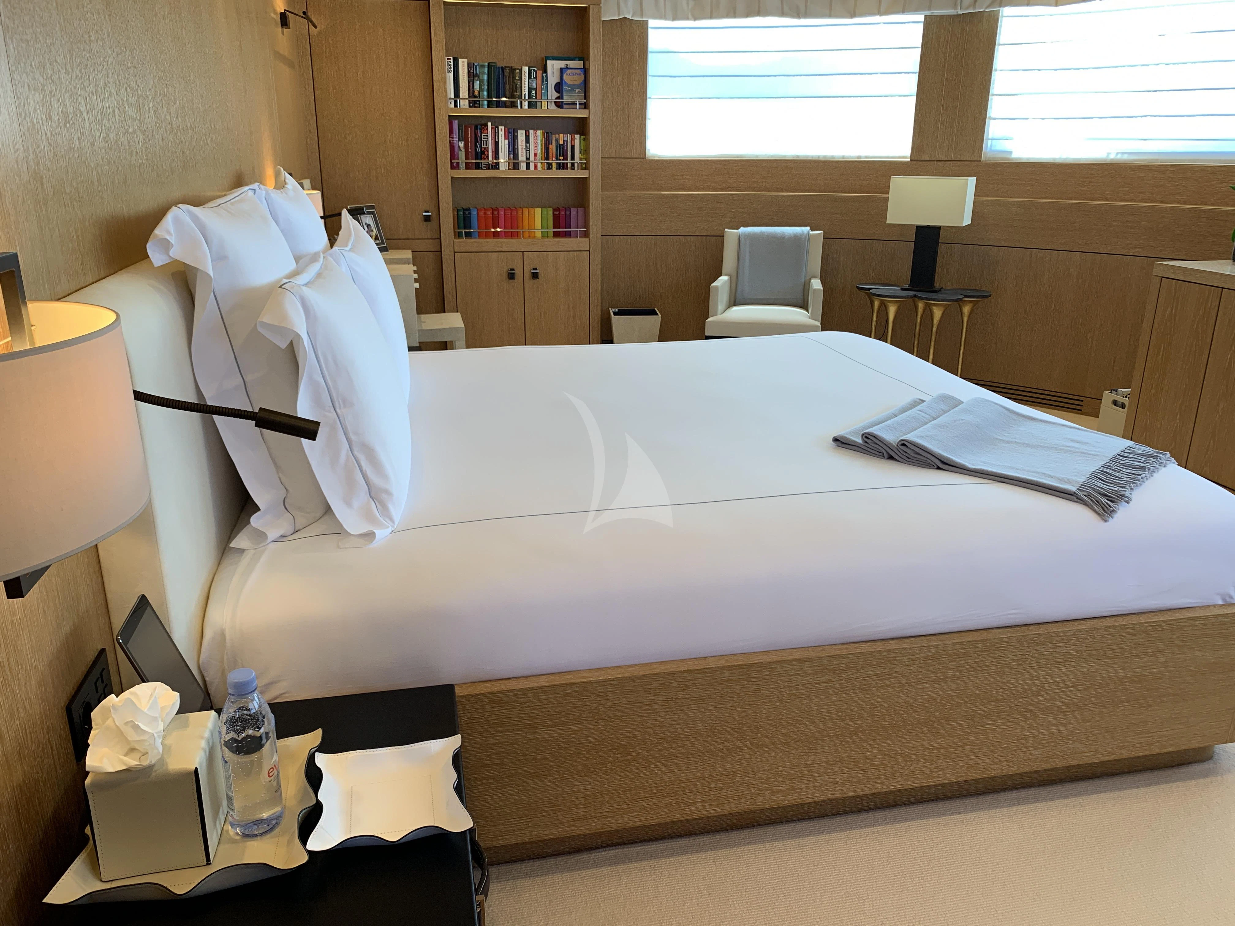 a bottle of water on a bed aboard BELONGERS Yacht for Sale