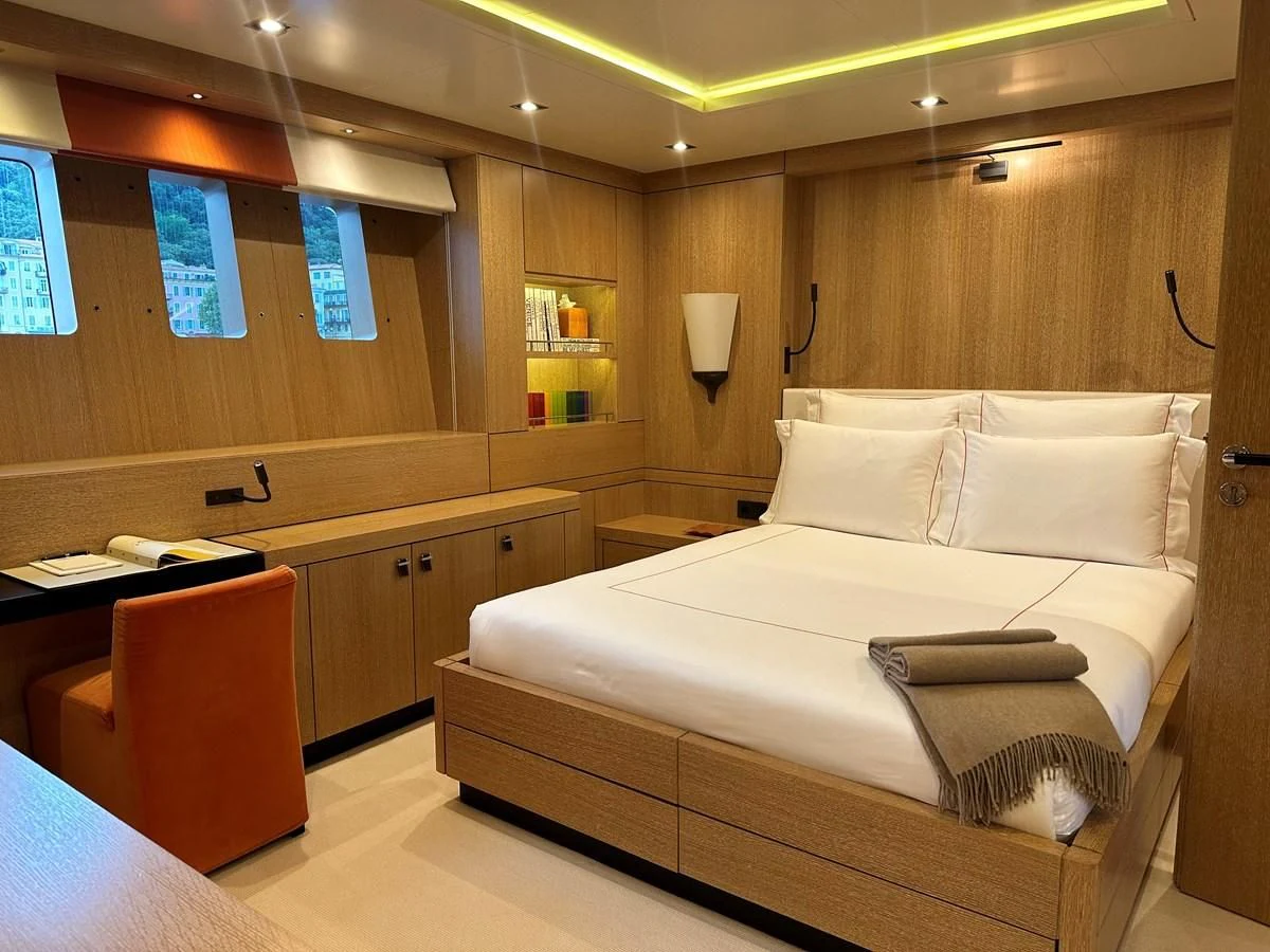 a room with a bed and desk aboard BELONGERS Yacht for Sale