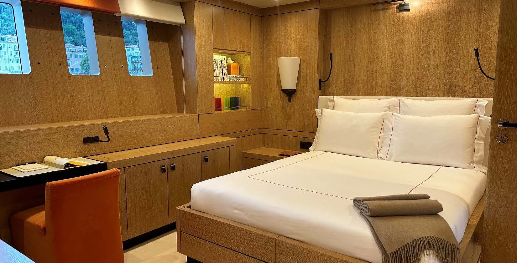 a room with a bed and desk aboard BELONGERS Yacht for Sale