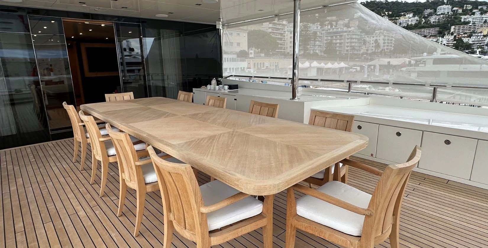 a table and chairs on a deck aboard BELONGERS Yacht for Sale