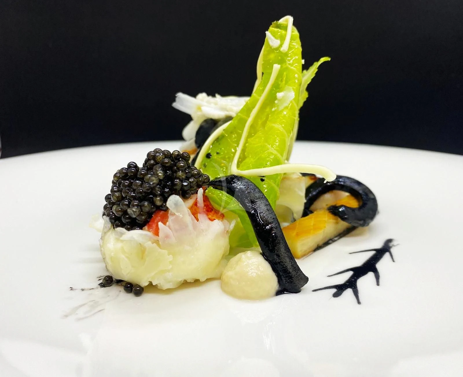 a white plate with a black bug on it and a green leaf aboard BELONGERS Yacht for Sale