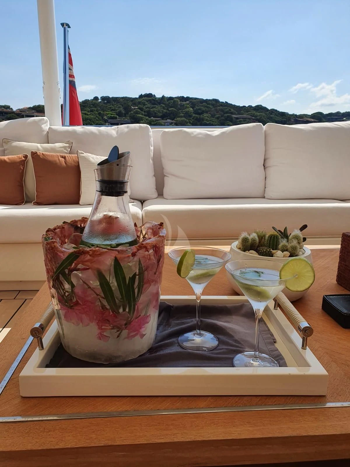 a bottle of wine and glasses on a table aboard BELONGERS Yacht for Sale