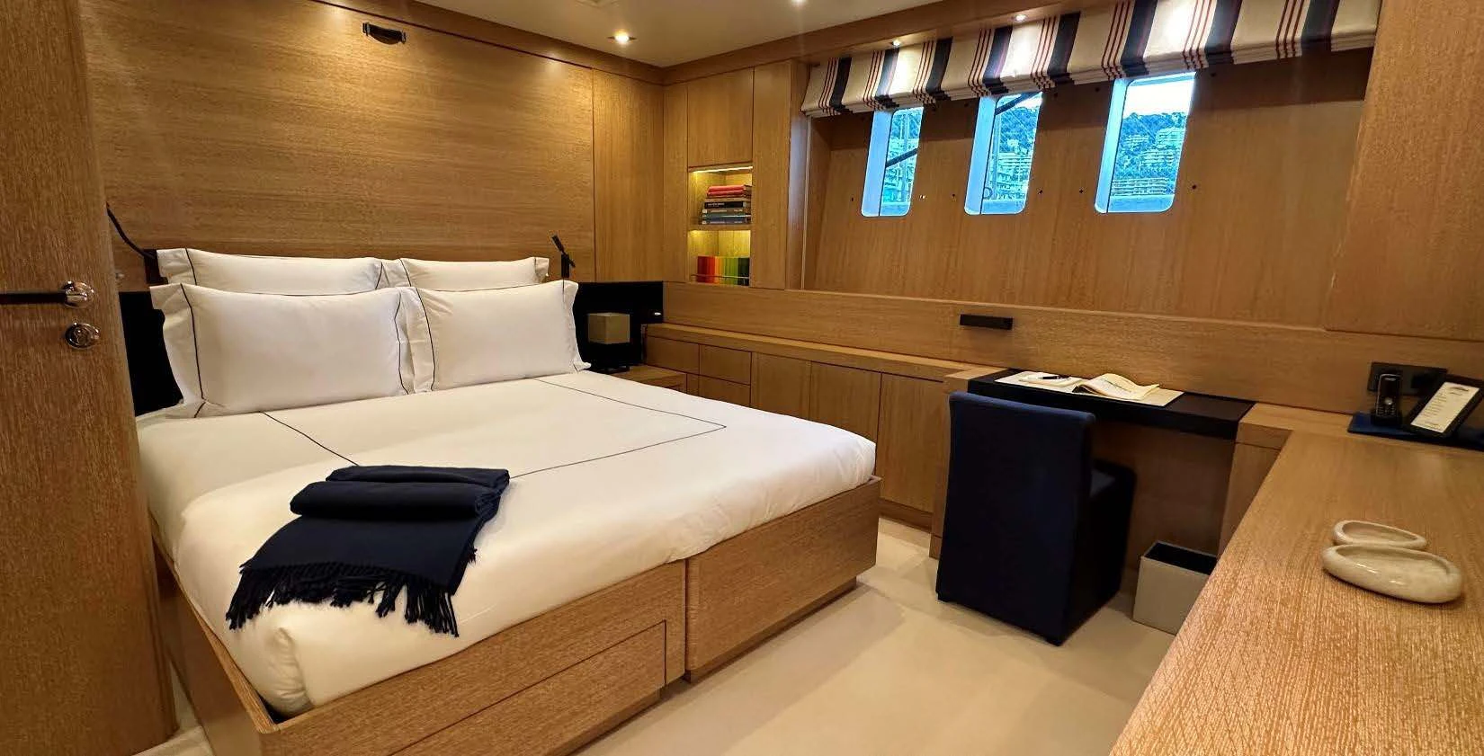 a room with a bed and desk aboard BELONGERS Yacht for Sale