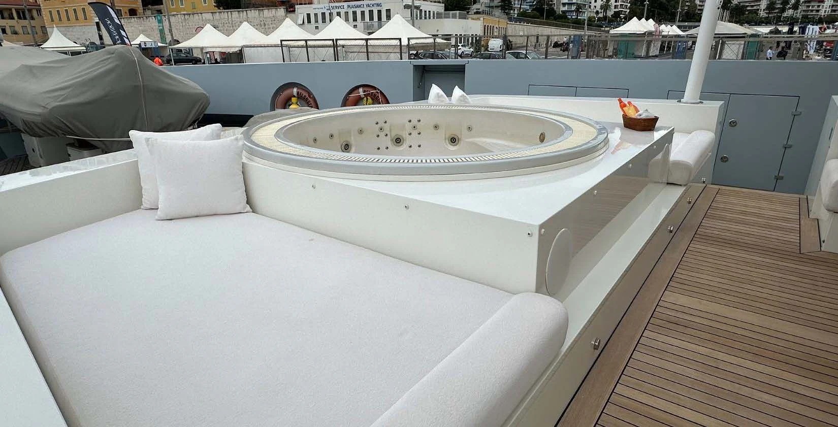 a white bathtub with a white cover and a white pillow on a wooden deck aboard BELONGERS Yacht for Sale
