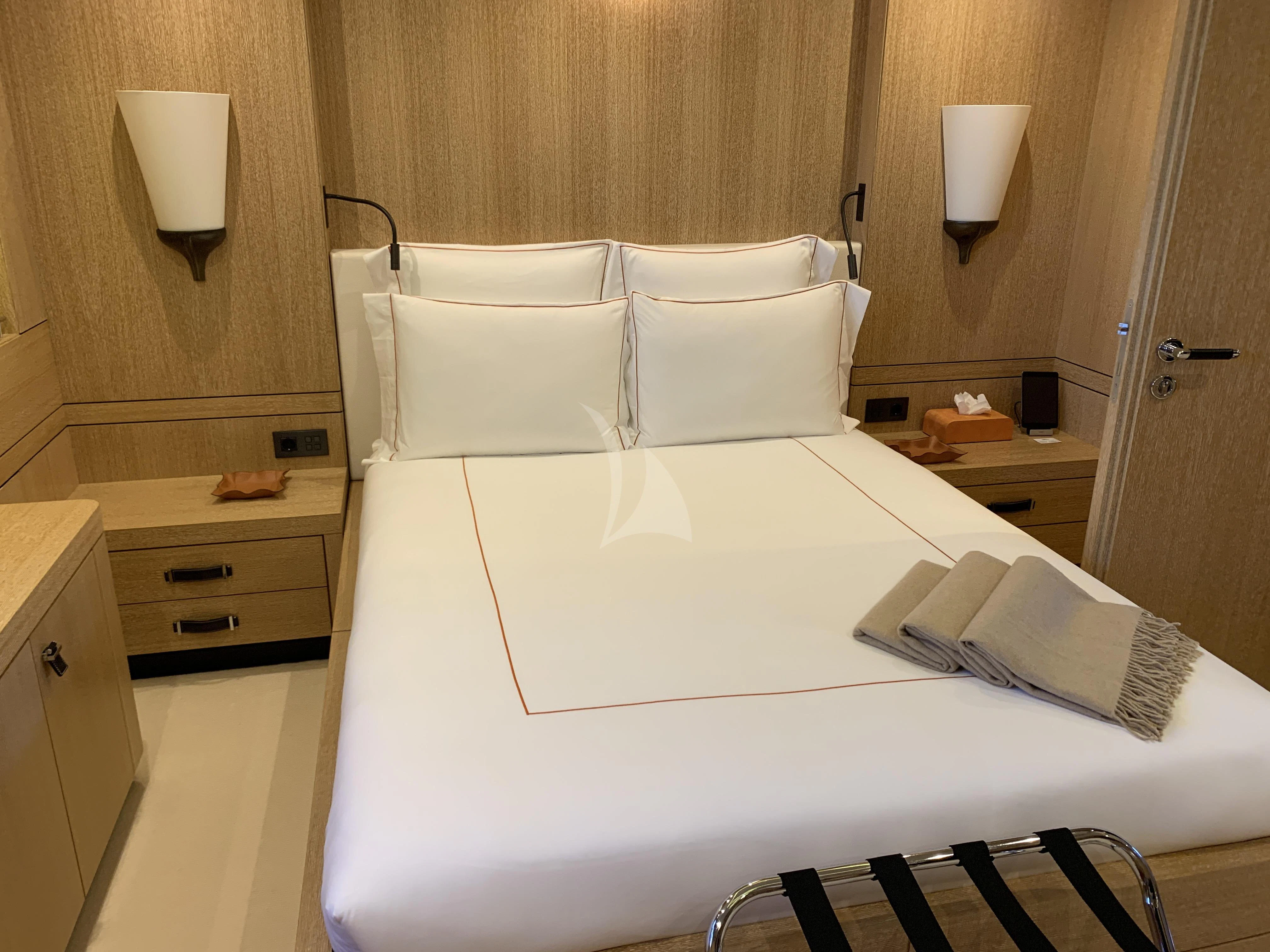 a bed with white sheets aboard BELONGERS Yacht for Sale