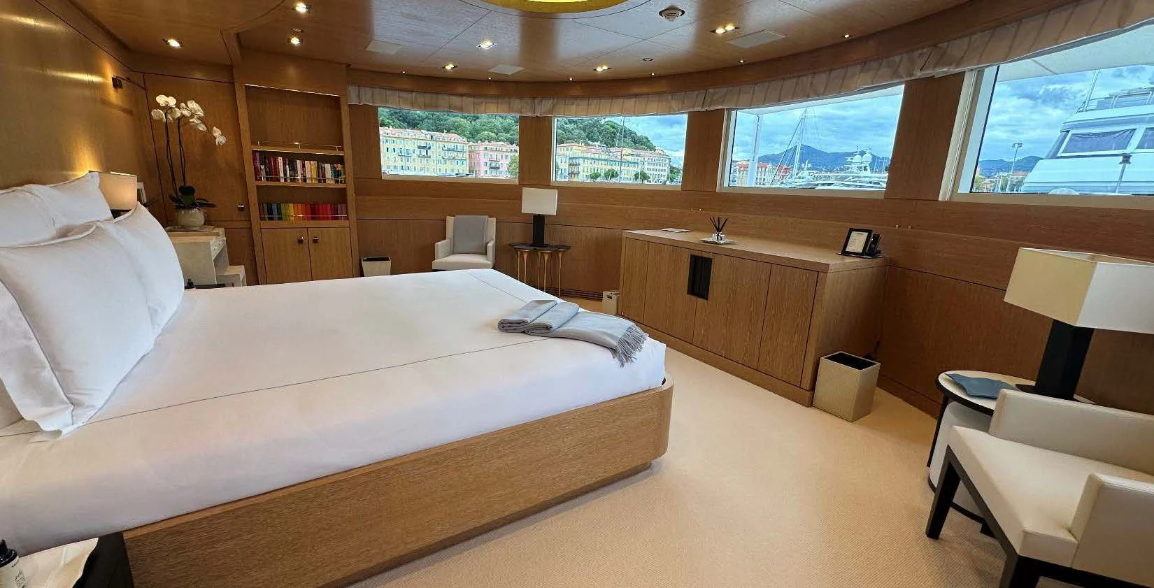 a large room with a bed and a desk aboard BELONGERS Yacht for Sale