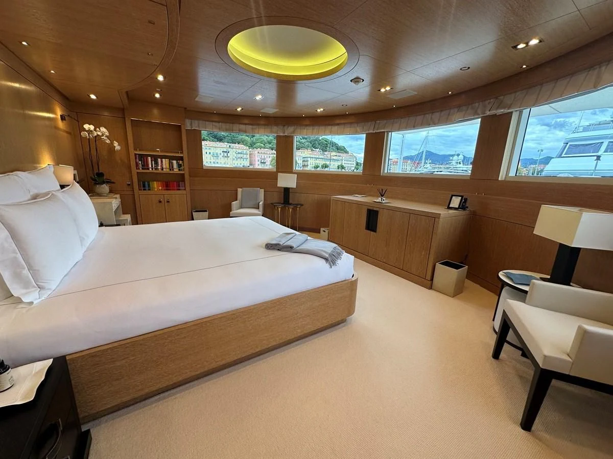 a room with a bed and a desk aboard BELONGERS Yacht for Sale
