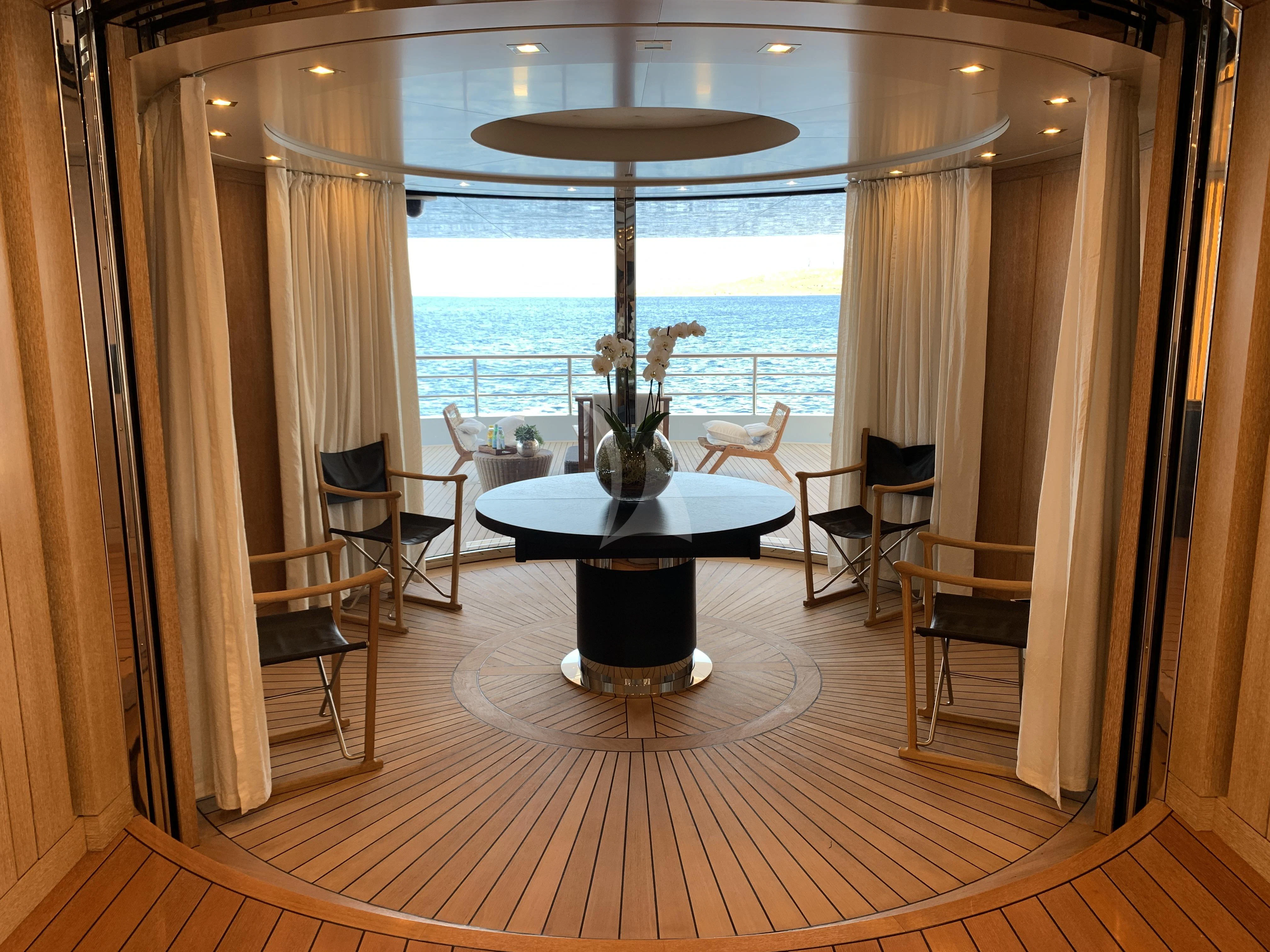 a room with a table and chairs aboard BELONGERS Yacht for Sale