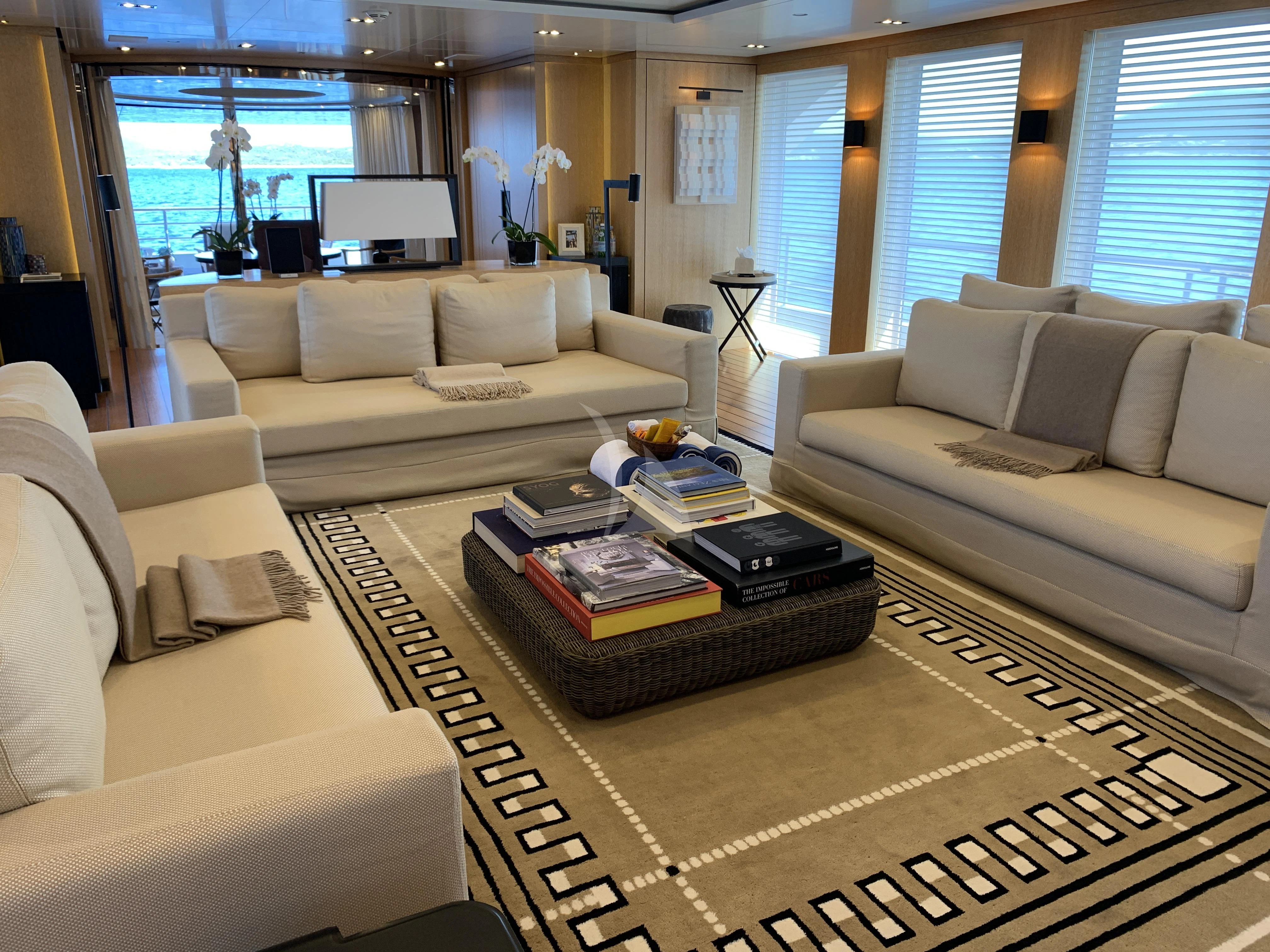 a living room with a couch and a coffee table aboard BELONGERS Yacht for Sale