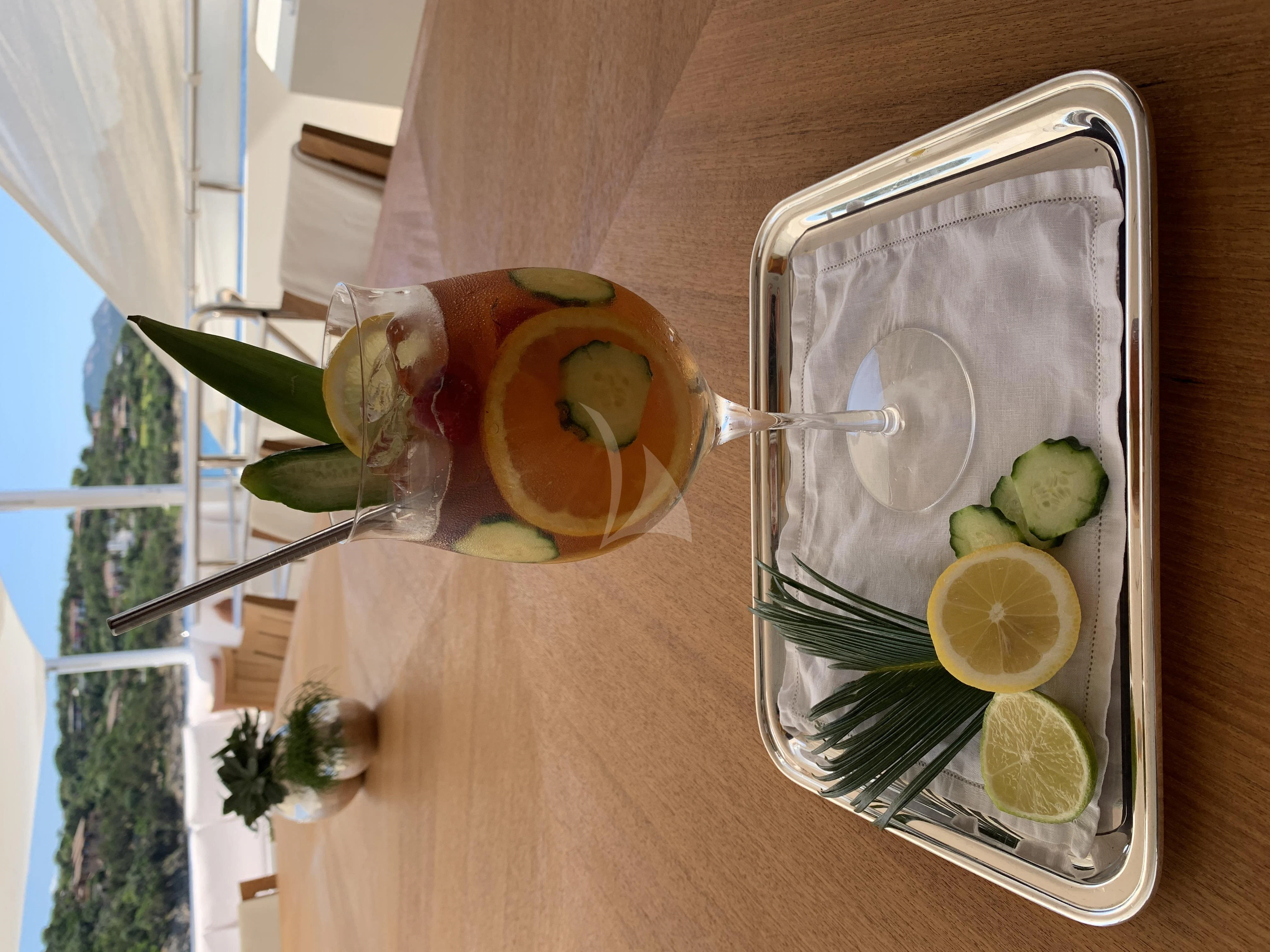 a glass with lemons and limes on a table aboard BELONGERS Yacht for Sale