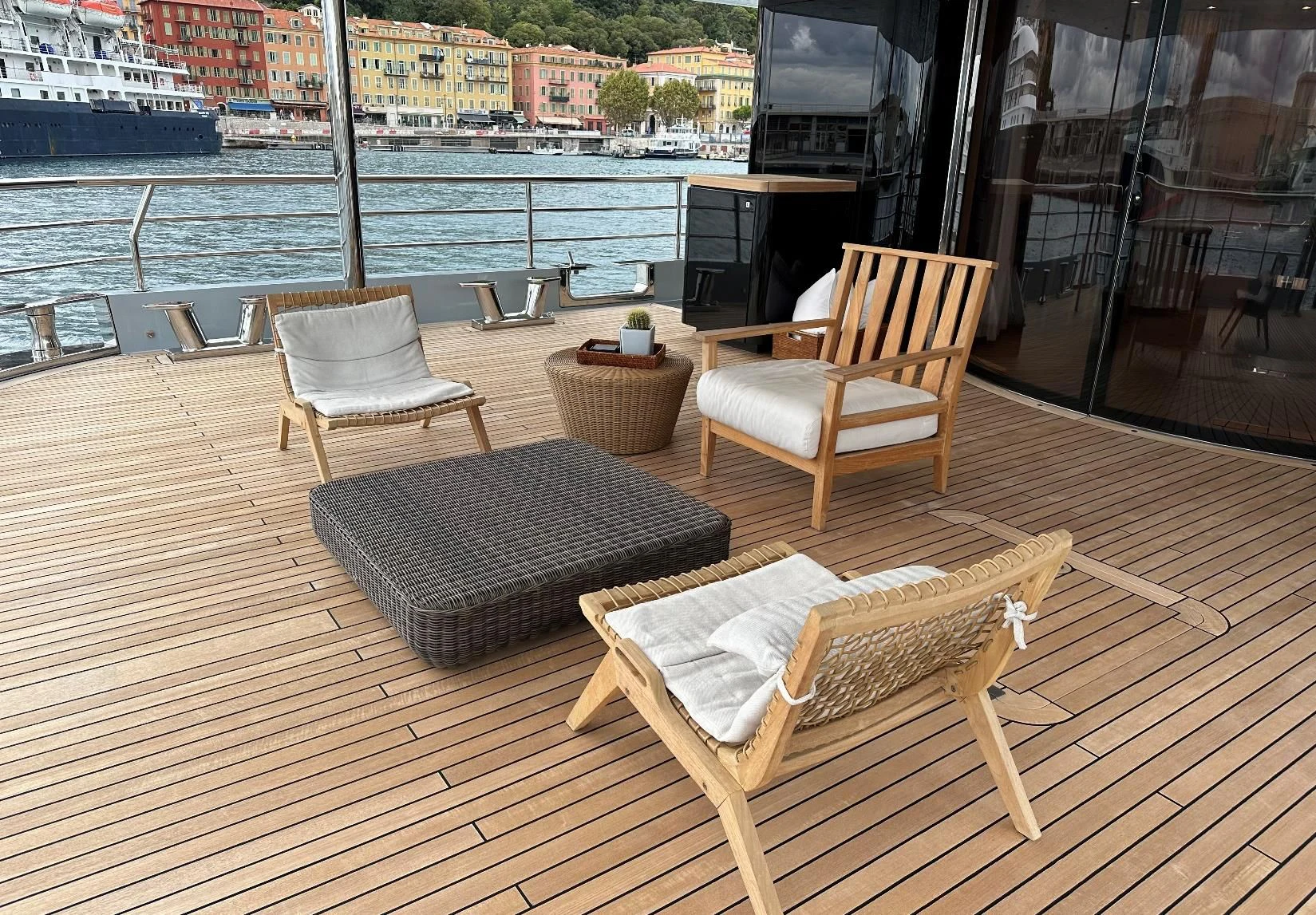 a couple of chairs on a deck overlooking a city aboard BELONGERS Yacht for Sale