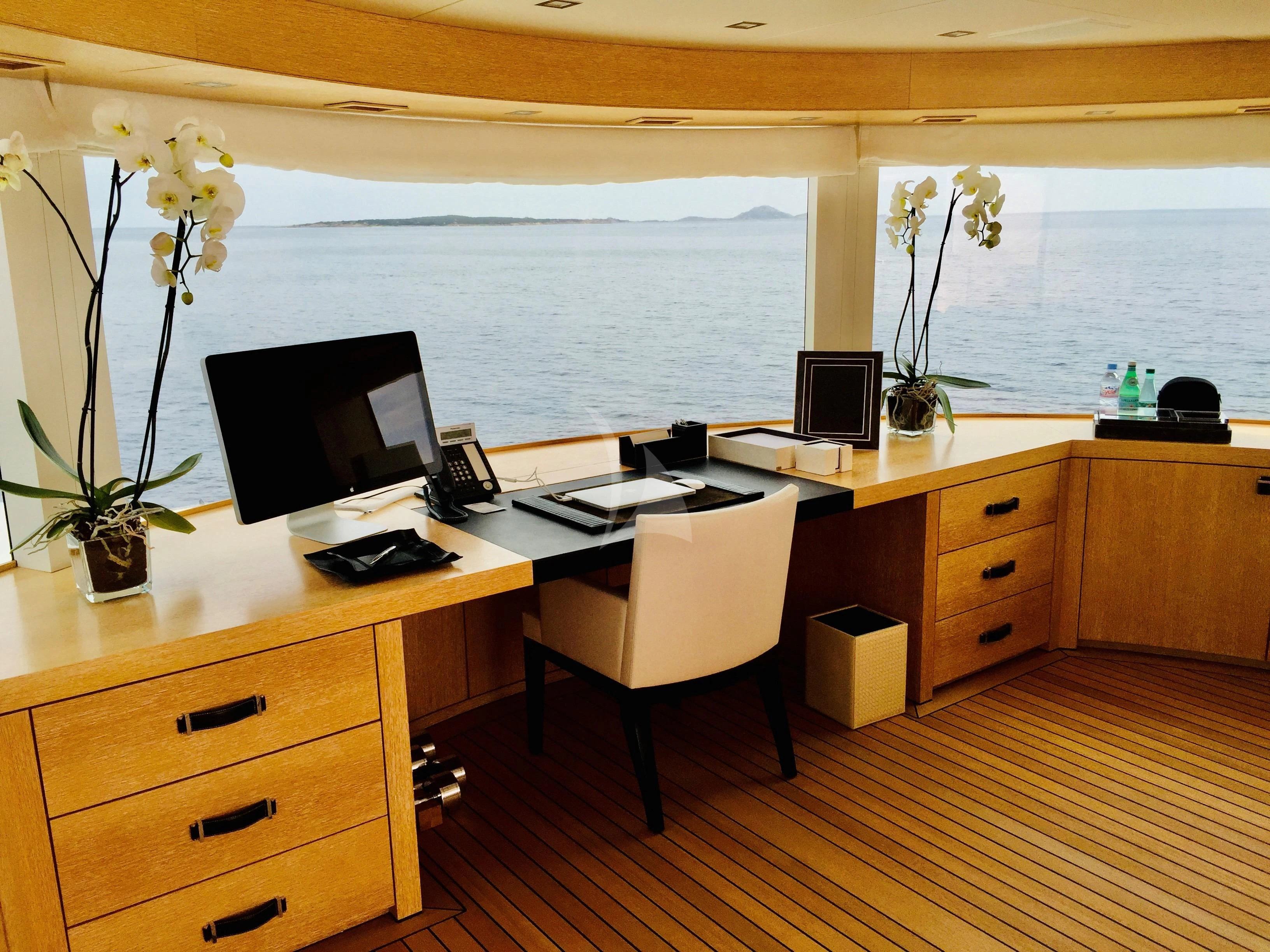 a room with a desk and a computer aboard BELONGERS Yacht for Sale