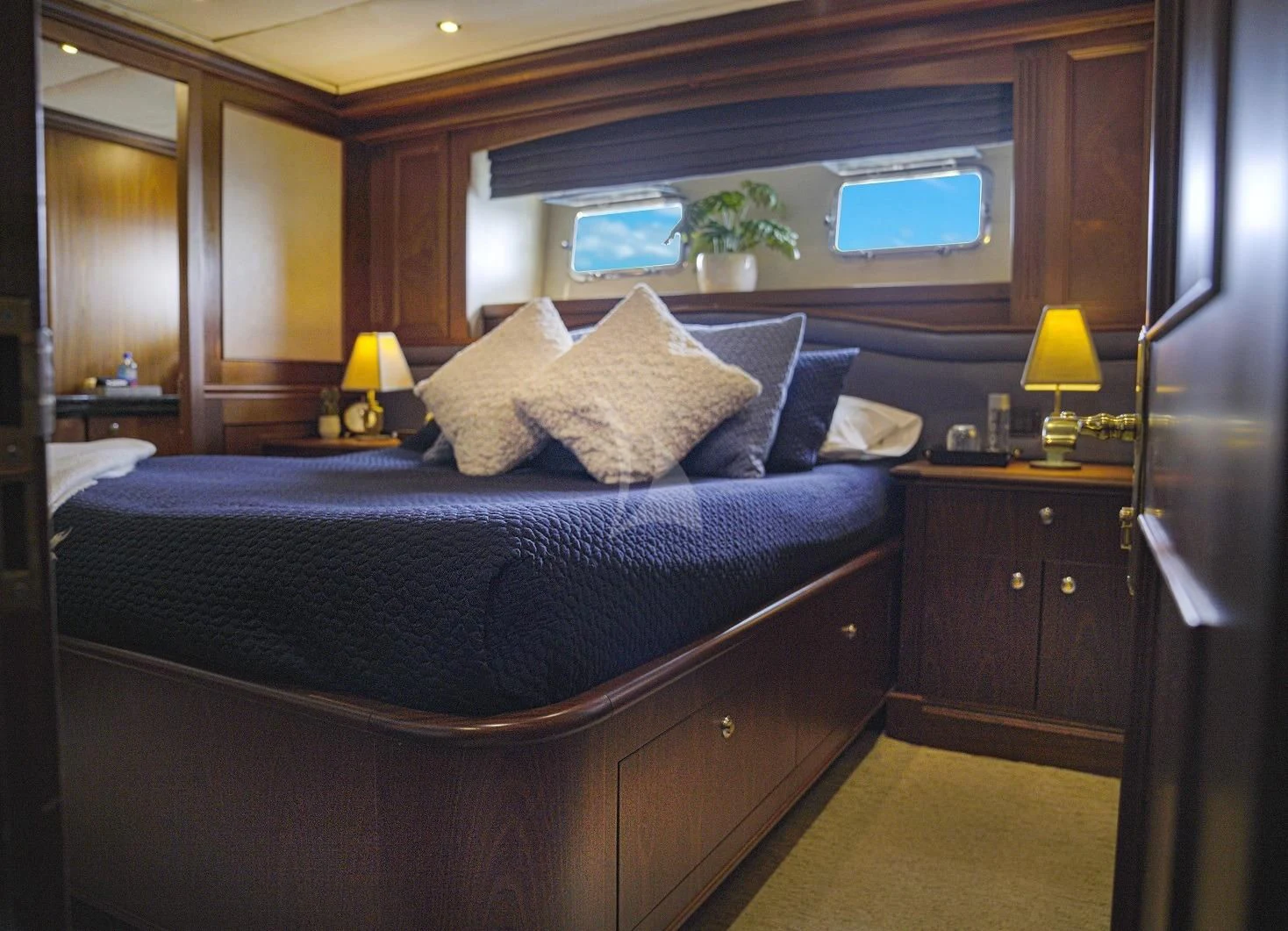 a bed with a blue comforter aboard LADY VICTORY Yacht for Sale