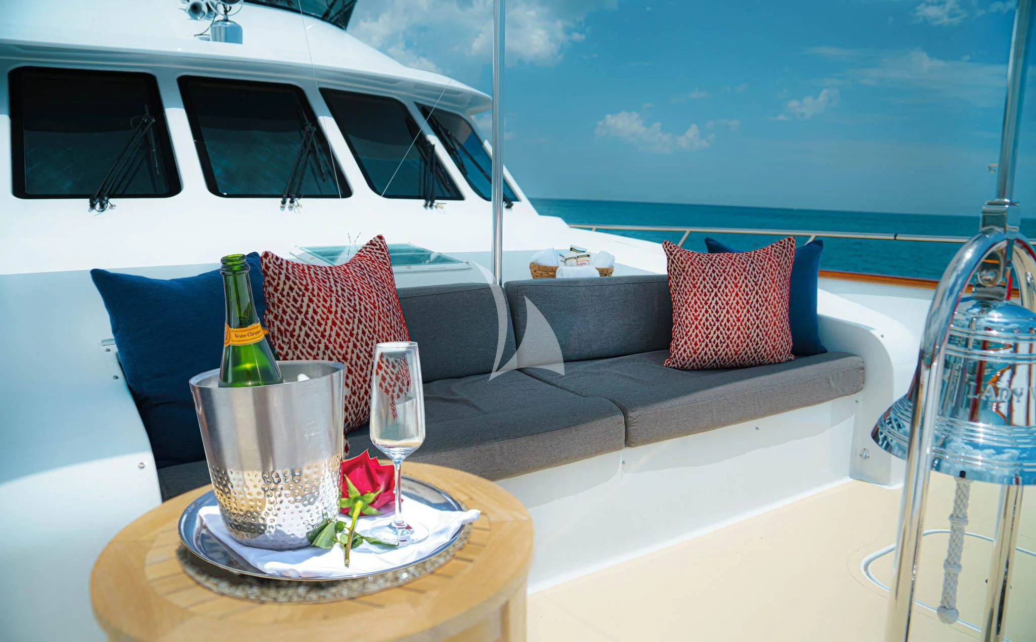 a table with a plate of food and a glass of wine on it aboard LADY VICTORY Yacht for Sale