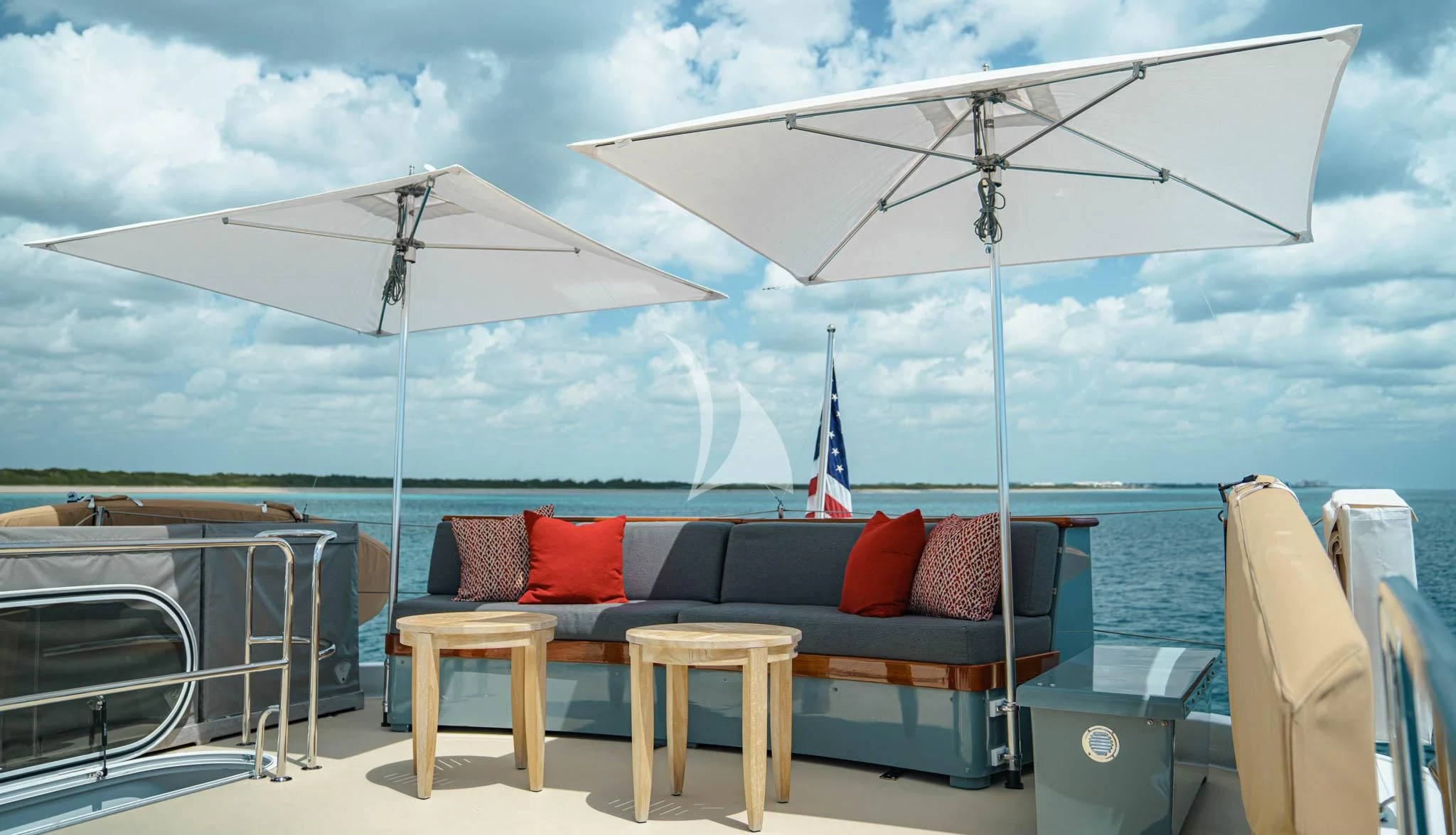 a couch and umbrella on a patio aboard LADY VICTORY Yacht for Sale