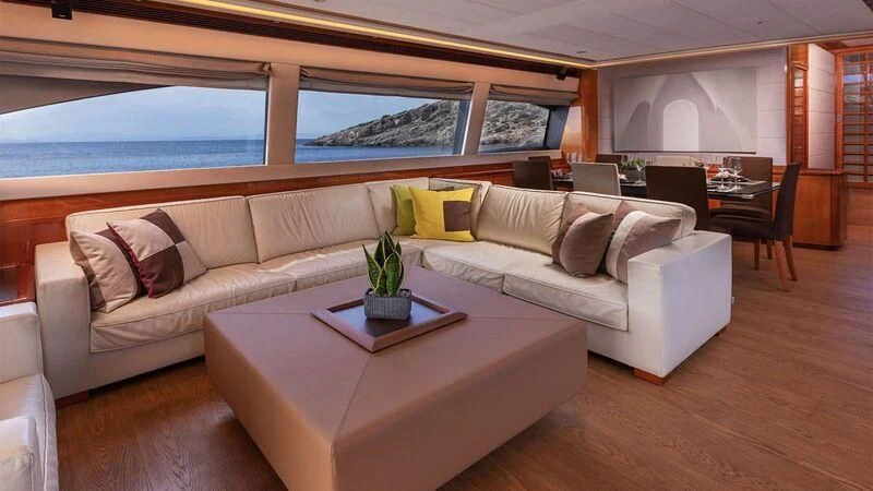 a living room with a couch and a table aboard ANNOUKA TWINS Yacht for Sale